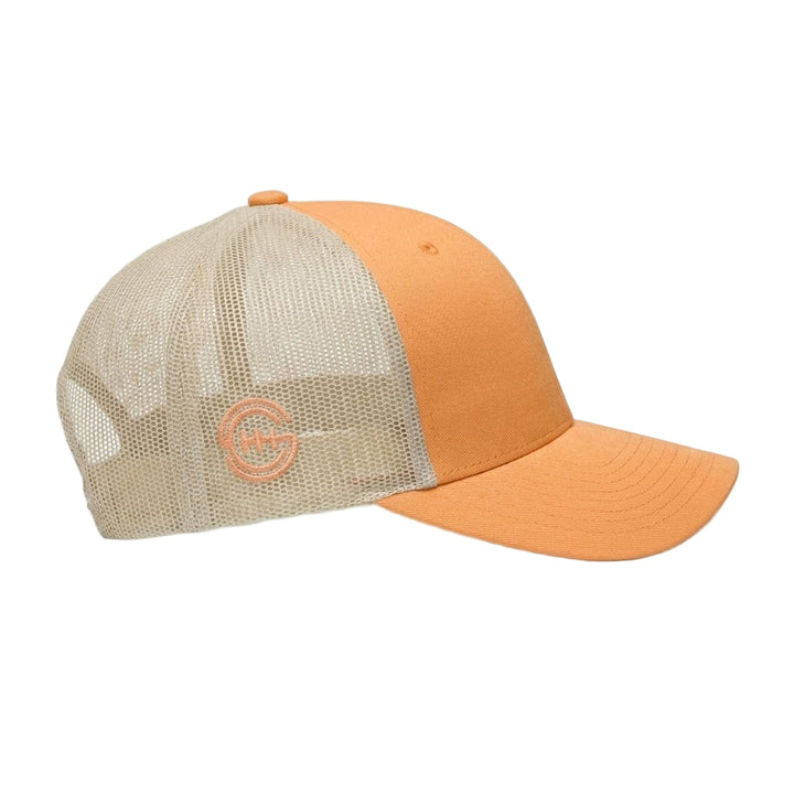 Side view of Shift Culture peach and cream mesh back hat with peach SC gear logo embroidered on side panel